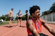 © Rawpixel.com - Happy male athlete with gold medal relaxing by the track