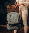 Woman's hands with Canvas Backpack accessories. Hand made backpack for travelers.
