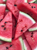 Fototapeta Tulipany - slices of fresh and ripe watermelon as a background