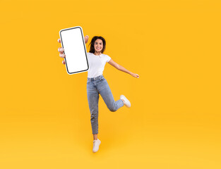 Aufkleber - Happy woman showing white empty smartphone screen and jumping