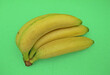 Banana fruits over green background