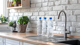 Fototapeta Desenie - Bottles of clean water and sink on kitchen counter near white brick wall