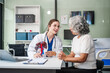 © NanSan - Caucasian woman accompanies an elderly Asian woman dealing with Hepatitis B, cirrhosis, and liver cancer. They seek medical advice and support together. Liver model learning