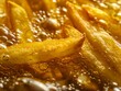 Macro shot of freshly fried French fries with oil bubbles, emphasizing texture and color.