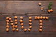 the word nut laid out with hazelnuts on a wooden background