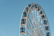 View of modern ferris wheel on background of blue sky in Kyiv city.