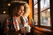 A young woman is sitting in a cafe and drinking coffee and looking out the window