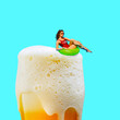 Beautiful stylish young girl swimming circle swimming on lager foamy beer against bright blue background. Contemporary art collage. Concept of alcohol drink, surrealism, celebration, creativity