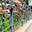 Display of love on a bridge in Gliwice, Poland. Padlocks in all colours are inscribed and locked onto the railing as a symbol of forever locked love.