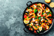 Traditional spanish seafood paella on gray stone. Top view. Copy space