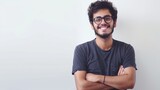 Fototapeta  - His arms folded, grin, and glasses-wearing Latin hipster on a white background