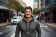 © CogniLens - Portrait of a smiling man in his 40s sporting a comfortable hoodie isolated in busy urban street