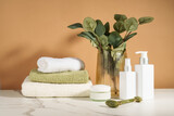 Fototapeta  - Bathroom with beauty products. Natural cosmetic, towels and vase with flowers.