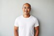 © CogniLens - Portrait of a blissful asian man in his 40s sporting a vintage band t-shirt isolated in modern minimalist interior