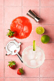 Fototapeta  - Margarita cocktails. Classic and strawberry margarita with tequila, ice and lime with ingredients at color background.