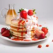 white cream pancake with  strawberry and maple syrup