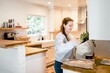 © Rawpixel.com - Brunette woman unpacking grocery bag in the kitchen