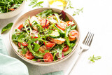 Fototapeta  - Green salad with baked chicken breast, fresh salad leaves and vegetables.