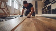 © retrostudio - Man installing new wooden laminate flooring on a film floor. floor heating system under laminate floor