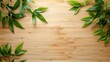 Green leaves scattered on a smooth bamboo wood surface, creating a natural and fresh background.