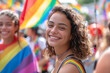 shot of a powerful moment of joy and empowerment as a young happy transgender person smiles on camera during a Gay Pride event, embracing the message of love and LGBTQ acceptance.