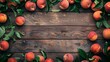 Ripe peaches with fresh leaves spread over a rustic wooden background, offering ample copy space.