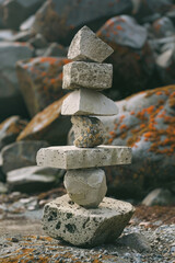 Poster - An artwork of stacked geometric shapes that appear to balance precariously, defying gravity and expectations,