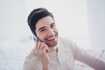 Canvas Print - Photo of attractive man speaking listening phone vacation morning cozy room white day light interior indoors