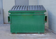 large green commercial dumpster for trash and recycling