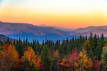 landscape of autumn mountain forest and mountain range in mist