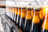 Fototapeta  - Banner Beer brewery conveyor. Brown glass alcohol bottles move on production line, modern equipment industrial drink with copy space