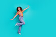 © deagreez - Photo of carefree lovely nice woman wear trendy print clothes dance empty space isolated on cyan color background