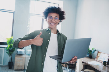 Sticker - Photo of cool smart employee wear khaki shirt eyeglasses showing thumb up working modern device indoors workstation workplace