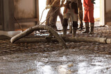 Fototapeta  - Workers work on concrete concreting floors of buildings in construction site, pouring cement