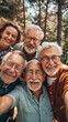 © Anastasiia Trembach - group of senior friends taking selfie with smartphone in forest during summer vacation