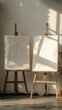 © Sasikharn - Two easels with white paper on them. The easels are wooden and are standing upright