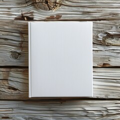 Aufkleber - A white book sits on a wooden table. The book is empty and has no writing on it. Concept of calm and simplicity