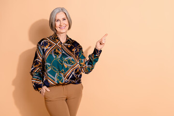 Poster - Portrait of good mood woman with bob hairdo dressed print shirt directing at offer empty space isolated on pastel color background