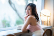 Portrait of beautiful happy Smiling asian woman relaxing sitting in cafe interior in coffee shop background,Business Lifestyle summer holiday concept