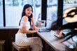 asian freelance people teenage businesswoman talking making using smartphone casual working with laptop computer in cafe coffee shop background,business expressed confidence embolden and successful