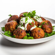 fried meatballs with herbs on white background