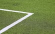 corner of an artificial turf green with a white line football field
