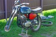 © FEDOR - one old  iron rusty  classical  heavy  blue  power broken dirty classic  retro industrial  motorcycle without front wheel  stands on the green grass   on the street