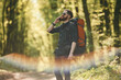 Colorful lens effect. Bearded man is in the forest at daytime