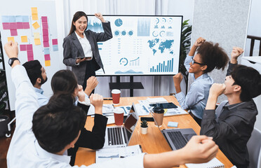 Wall Mural - Business people celebrate after successful presentation or meeting on data analysis display on TV screen. Happy team gathers in office room, cheer to collaboration with celebratory gesture. Concord