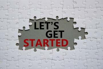lets get started symbol. concept words lets get started on white puzzle. beautiful grey background. 
