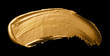 trace of gold paint on a black background	