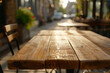 Empty natural wood table top in outdoors terrace, cafe. Empty backdrop on empty wooden table for food, drink, product with city street background