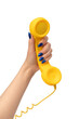 © Nikolay - Yellow handset in woman hand isolated on white. Copy space.