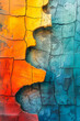 Abstract background of vibrant cracked paint on a surface, featuring a gradient of colors